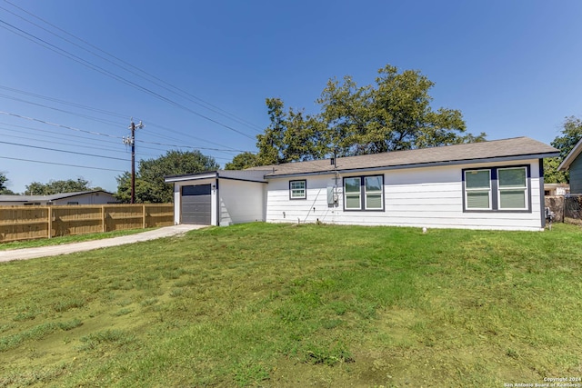 single story home with a garage and a front yard