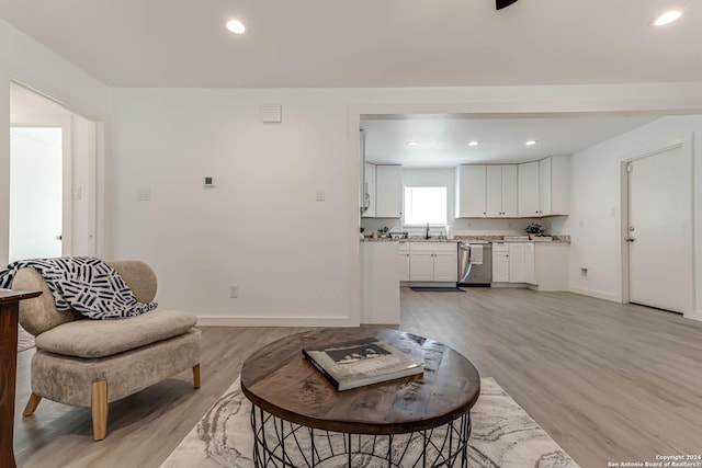 living room with sink and light hardwood / wood-style floors