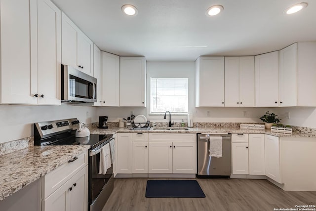 kitchen featuring sink, white cabinets, and appliances with stainless steel finishes