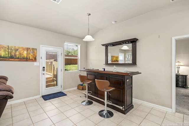 interior space with vaulted ceiling and light tile patterned floors