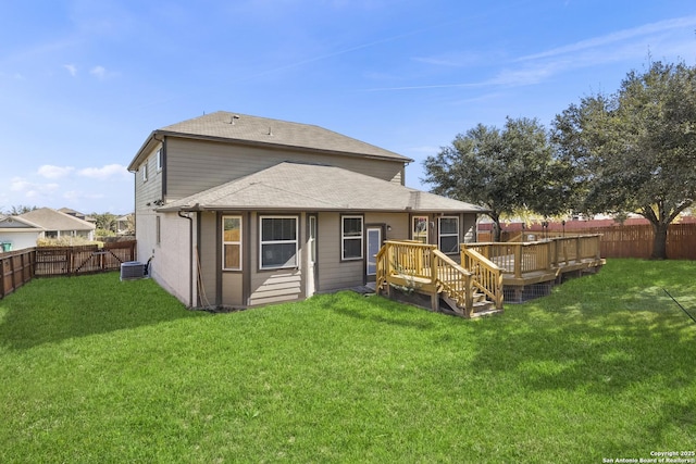 back of property with a wooden deck, a yard, and central air condition unit