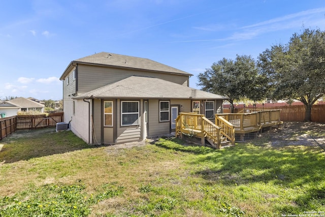 rear view of property featuring a deck and a lawn