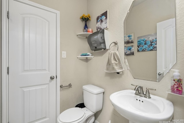 bathroom featuring sink and toilet