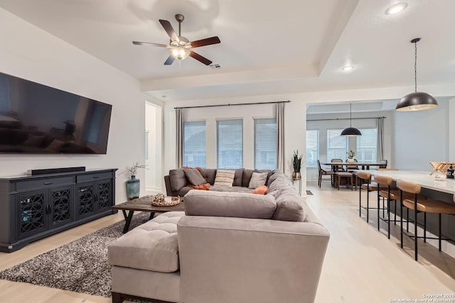 living area with recessed lighting, a ceiling fan, and light wood-style floors