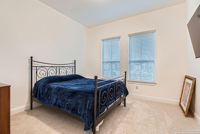 carpeted bedroom featuring baseboards