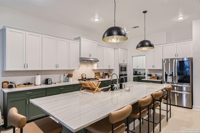 kitchen featuring visible vents, white cabinets, stainless steel appliances, and green cabinets