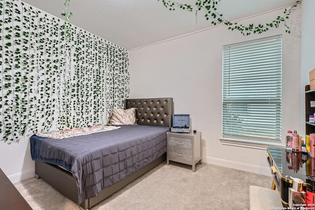 carpeted bedroom featuring baseboards