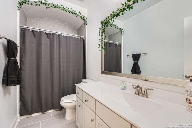 bathroom featuring curtained shower, toilet, and vanity