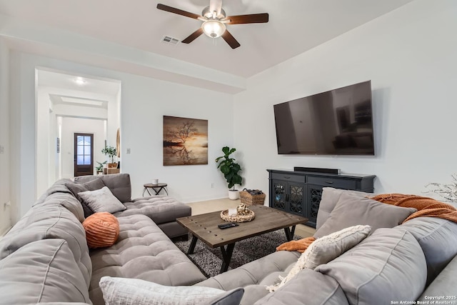 living area featuring visible vents and ceiling fan