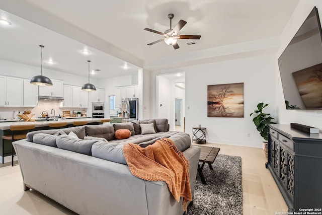 living room with visible vents and ceiling fan