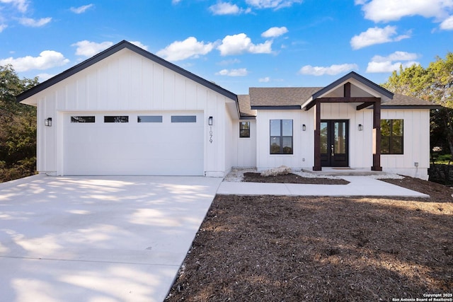 modern inspired farmhouse with a garage and french doors