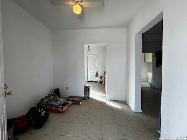 unfurnished room featuring light tile patterned floors and ceiling fan