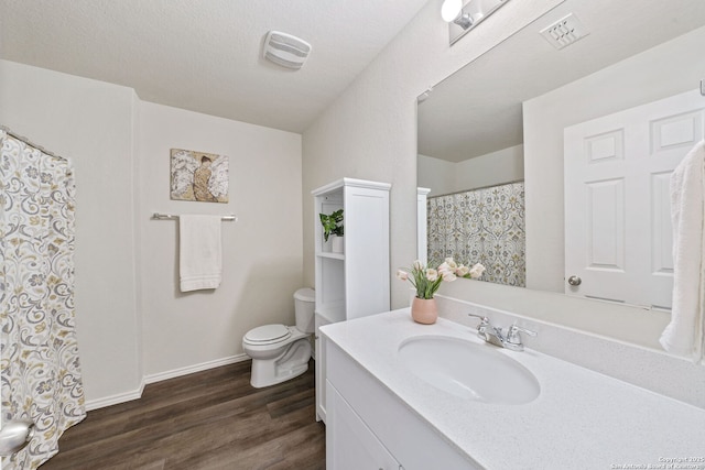 bathroom featuring hardwood / wood-style flooring, vanity, and toilet