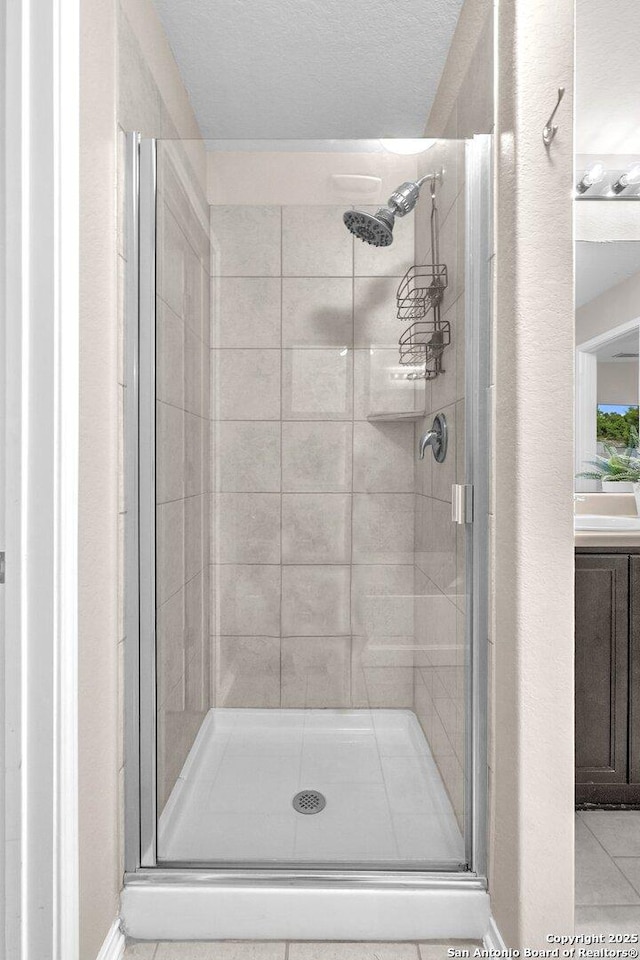 bathroom with tile patterned floors and walk in shower