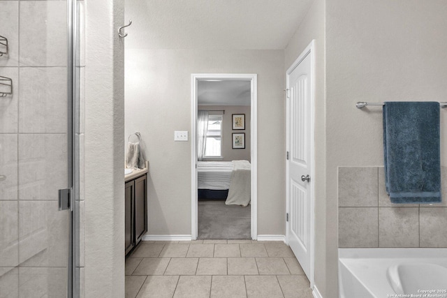 bathroom with tile patterned flooring, vanity, and shower with separate bathtub