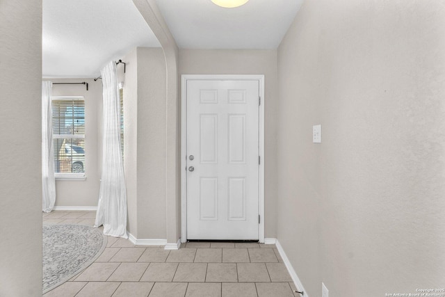 doorway to outside featuring light tile patterned flooring