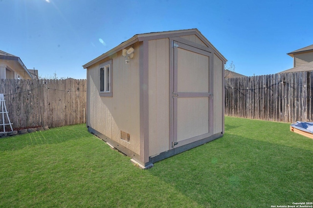 view of outbuilding with a yard