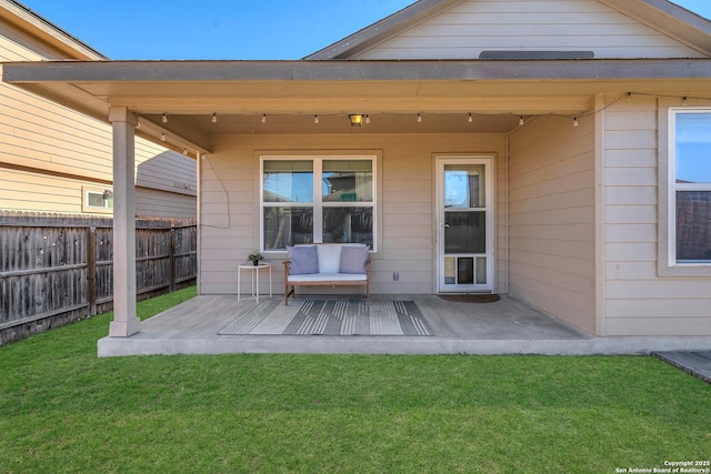 back of house featuring a wooden deck, a yard, and a patio area