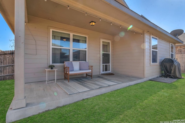 wooden terrace with a yard and grilling area