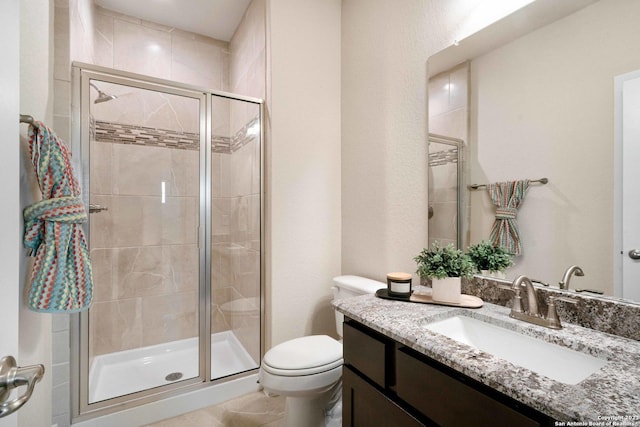 bathroom with walk in shower, vanity, and toilet