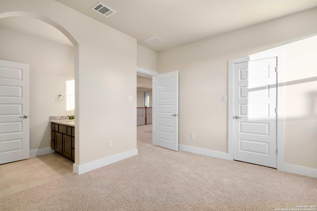 unfurnished bedroom with light carpet