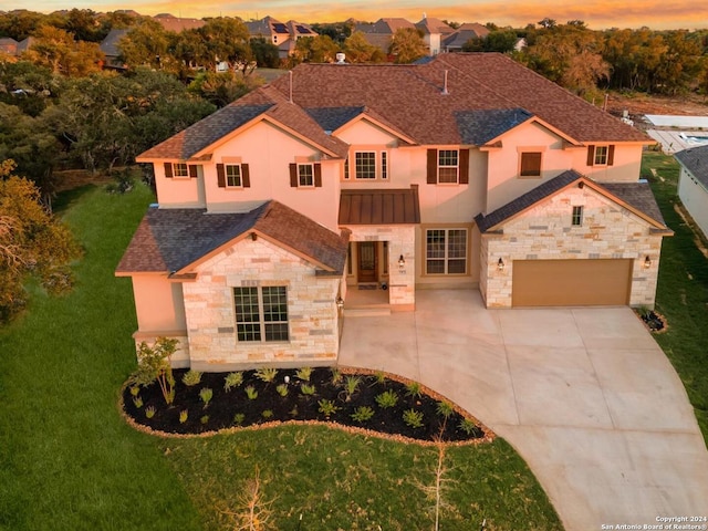 view of front of house with a yard and a garage