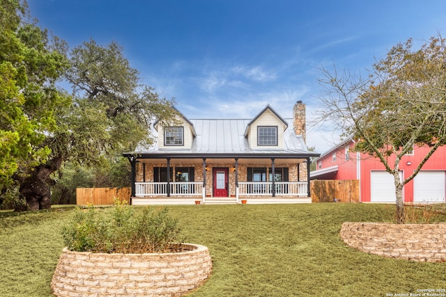 view of front of home featuring a garage, covered porch, and a front lawn