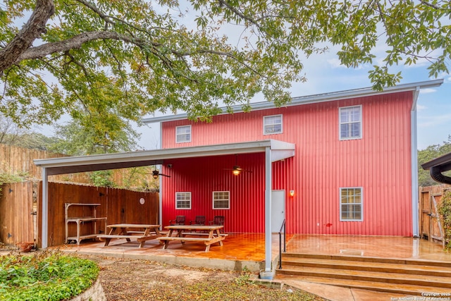 back of house featuring a wooden deck