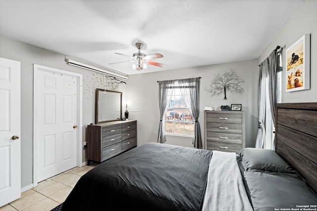 bedroom with light tile patterned floors and ceiling fan