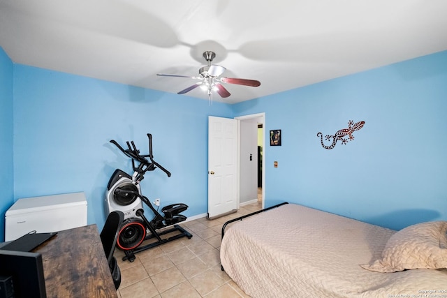 tiled bedroom featuring ceiling fan