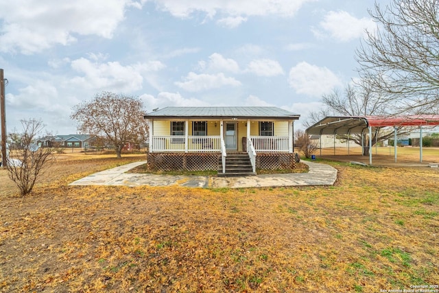 bungalow featuring a carport, a porch, and a front yard