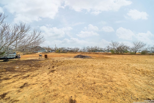 view of yard with a rural view