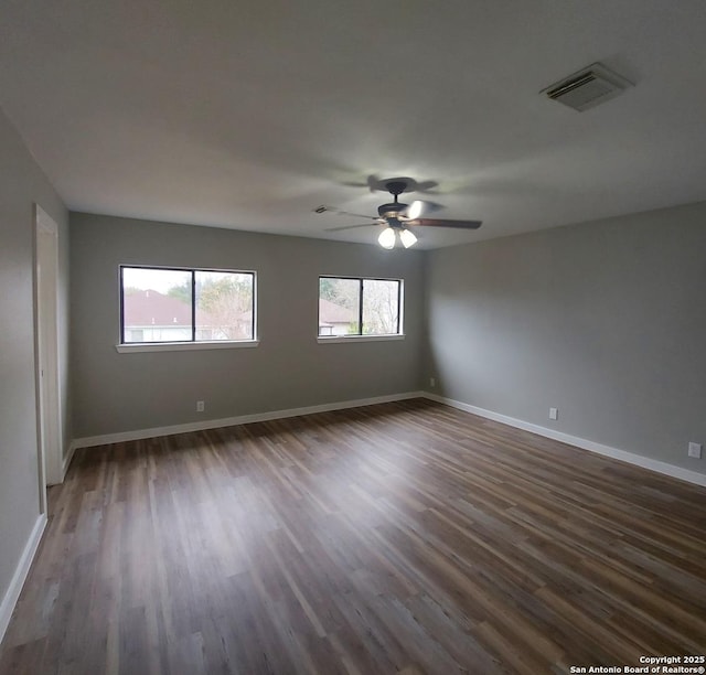 unfurnished room featuring ceiling fan and dark hardwood / wood-style flooring