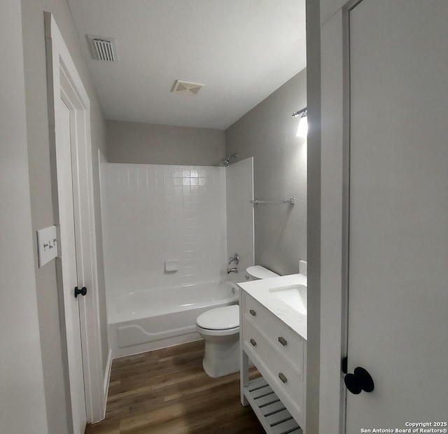 full bathroom with wood-type flooring, toilet, shower / bath combination, and vanity