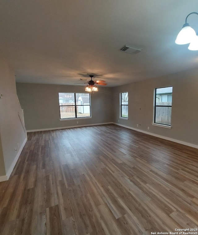 unfurnished room with ceiling fan and dark hardwood / wood-style floors