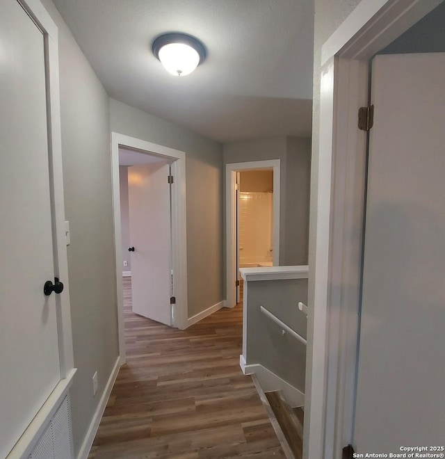 hallway featuring dark hardwood / wood-style flooring