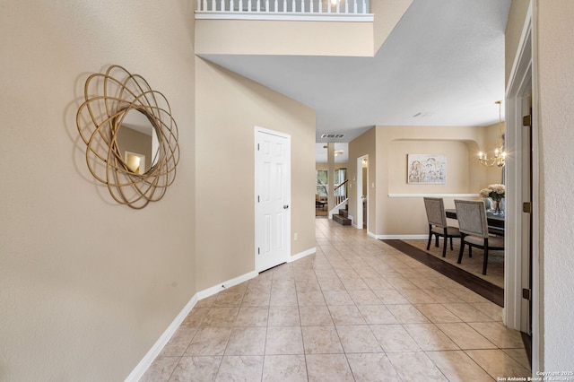 foyer with tile patterned floors and a chandelier