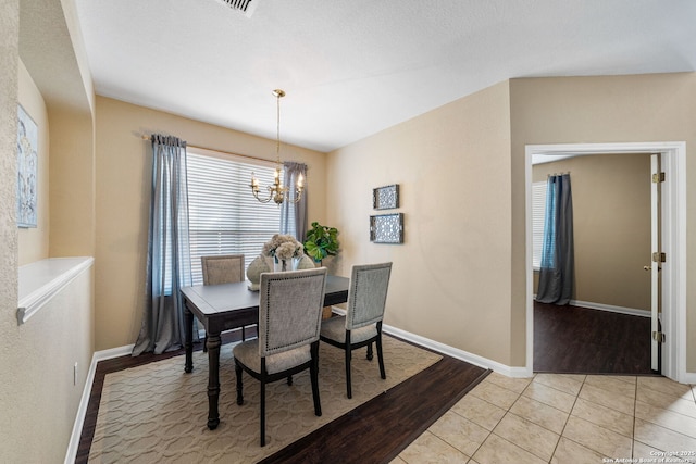 tiled dining area with a notable chandelier