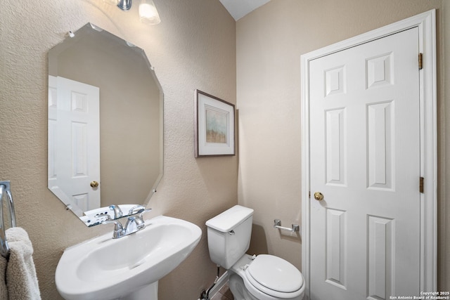 bathroom featuring sink and toilet