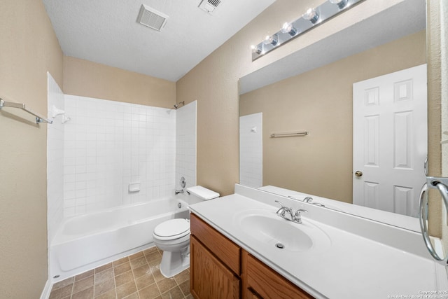 full bathroom featuring washtub / shower combination, toilet, vanity, and a textured ceiling