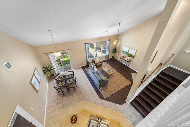 living room featuring high vaulted ceiling and light tile patterned floors