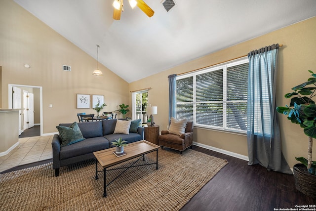 living room with high vaulted ceiling, ceiling fan, and wood-type flooring