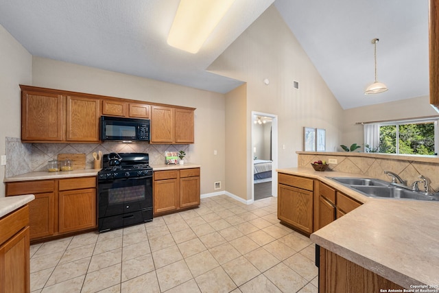 kitchen with black appliances, sink, backsplash, light tile patterned floors, and pendant lighting