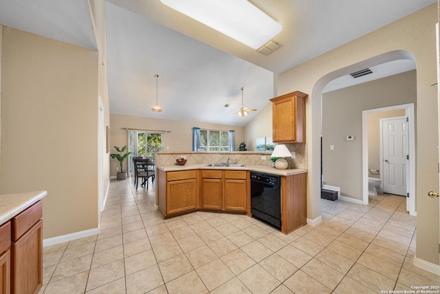 kitchen with lofted ceiling, sink, black dishwasher, kitchen peninsula, and decorative backsplash