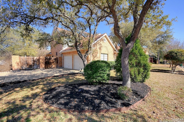 view of front of house featuring a garage and a front lawn