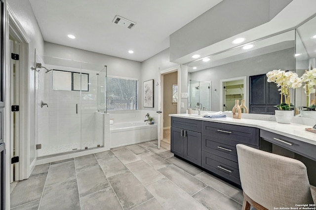 bathroom with independent shower and bath and vanity