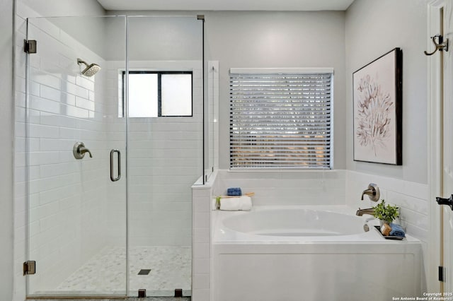 bathroom with separate shower and tub