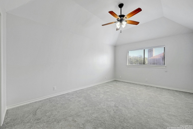 empty room with ceiling fan, carpet flooring, and vaulted ceiling