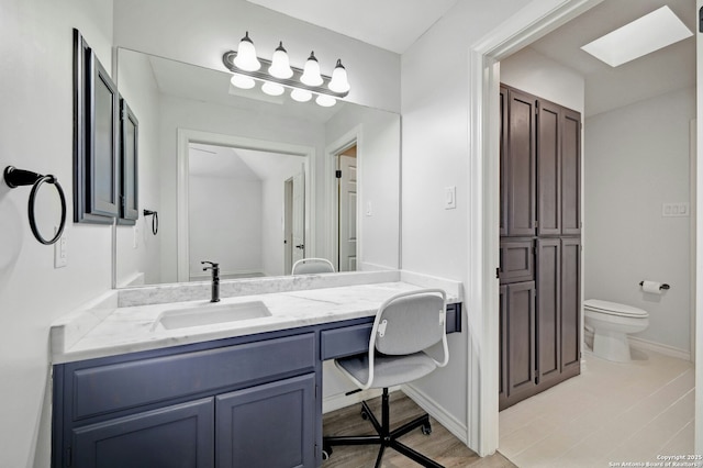 bathroom with vanity, wood-type flooring, and toilet