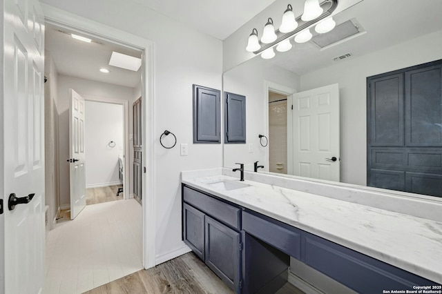 bathroom with vanity and hardwood / wood-style floors